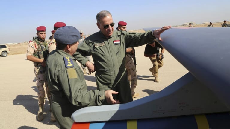 Then Iraqi Defence Minister Khaled al-Obeidi, centre, inspects the first Chinese drone to be used by the Iraqi Air Force before sending it to bomb Islamic State group positions in 2015.