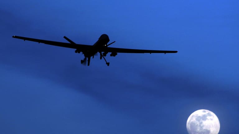 An unmanned US Predator drone flies over Kandahar Air Field, southern Afghanistan, on a moon-lit night.