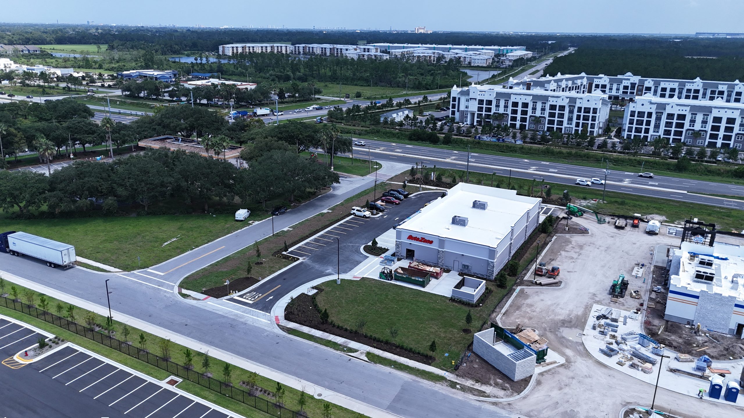 Drone view of the AutoZone property and adjacent construction activity in Daytona Beach