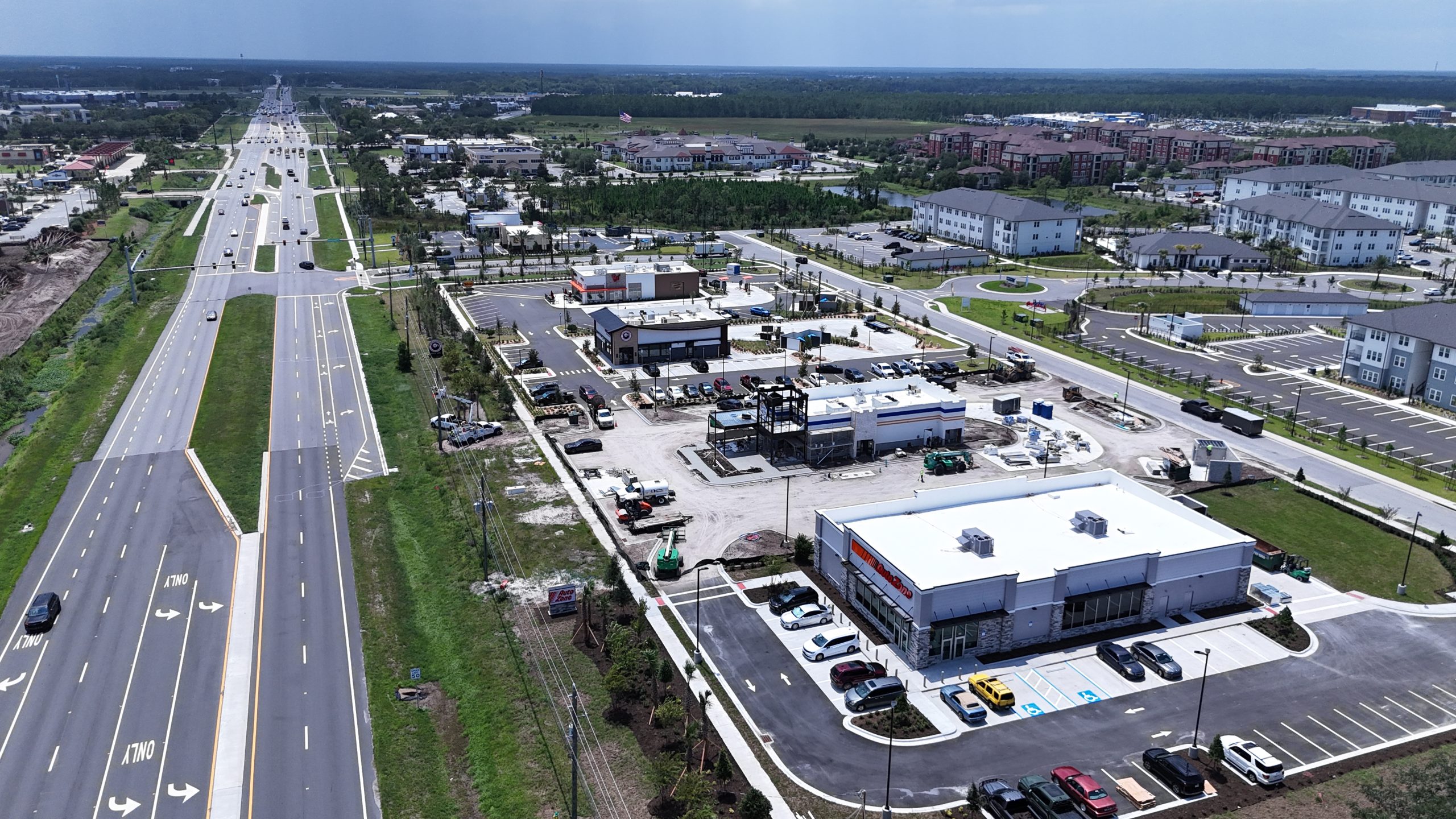 Aerial view along LPGA Boulevard showing the AutoZone site and surrounding Daytona Beach development